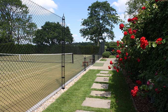 Rose bushes frame an eyegant tennis court built by AMSS