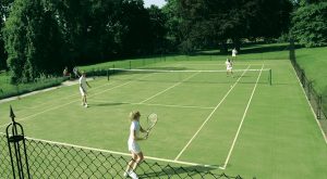 Foursomes on a tenns court built by En Tout Cas. Cotswold Tennis Courts. Fake grass.