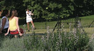 Girl playing tennis on a court built by En Tout Cas